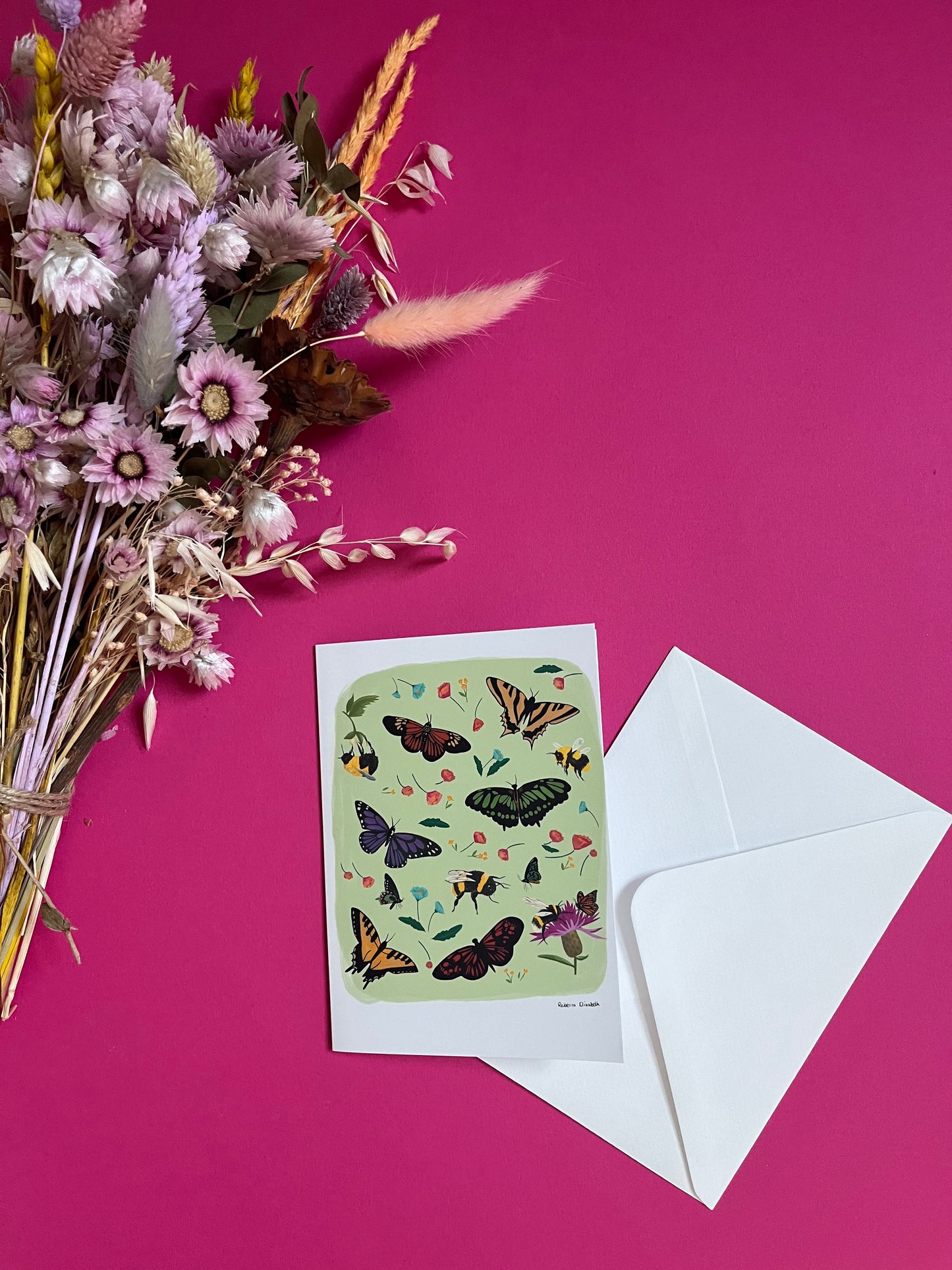A collection of wildflowers, bumblebees and butterflies hand painted in gouache and edited digitally into a collaged design on a light green background. With a green back and the Rebecca Elizabeth Draws logo.