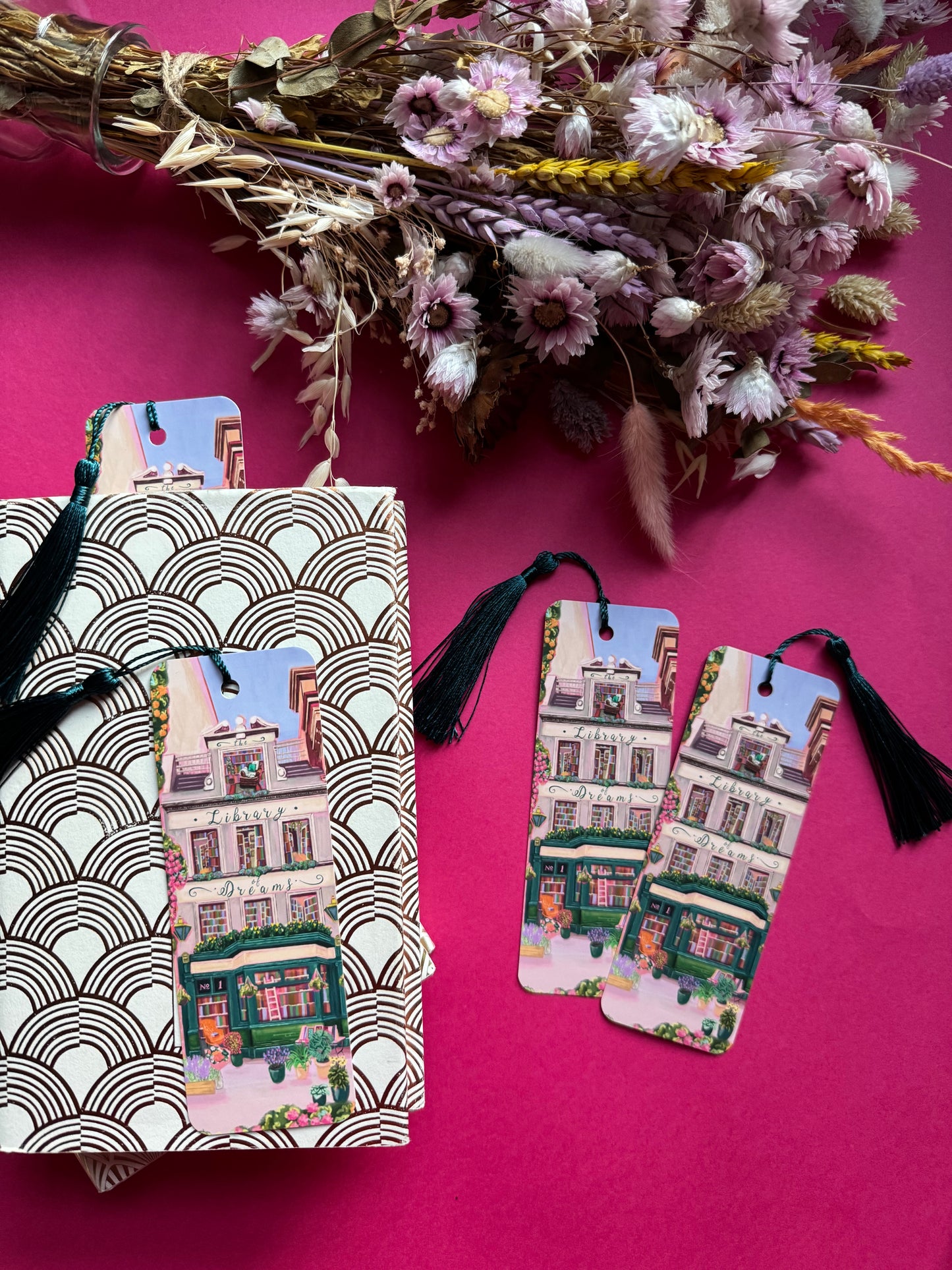 4 storey town house library with windows showing bookcases stacked full of books, covered with flowers & plants. A fantasy library perfect for cosying up with a good book designed by Rebecca Elizabeth Draws