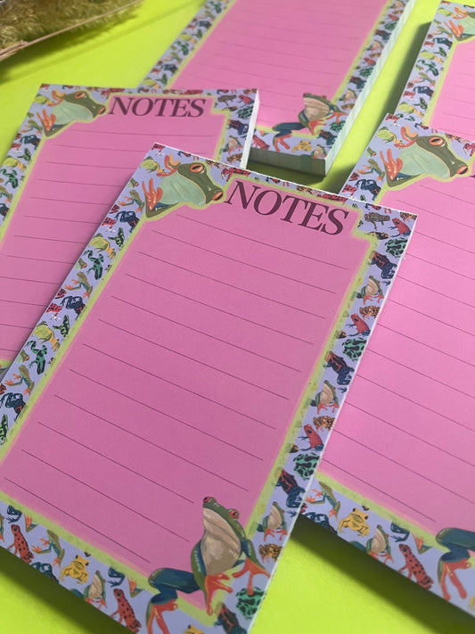 frog pattern notepad with purple background and a pink notes section. A couple of prominent frog’s peer around the notes. There is an accent colour of green, designed by Rebecca Elizabeth Draws.
