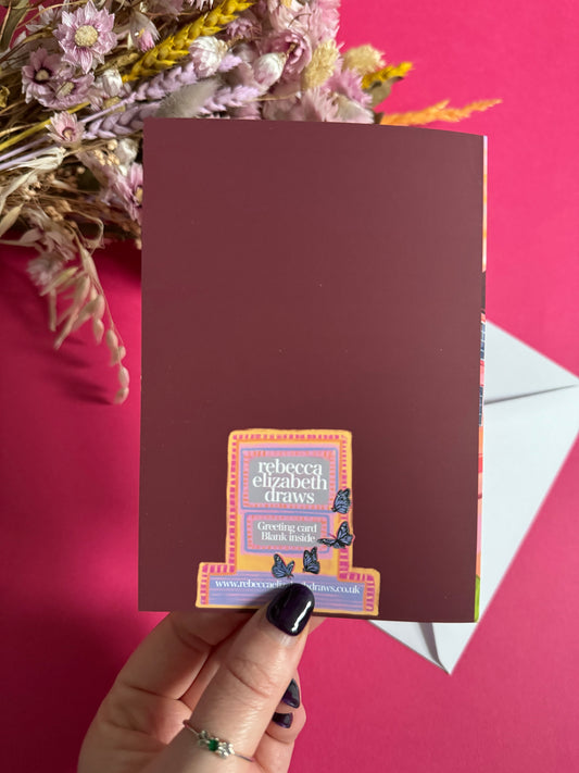 An illustrated greeting card of Sheffield city, Yorkshire. Featuring The Leadmill, the Lyceum, Sheffield train station, Sheffield Park Hill flats, park hill graffiti and water features. This illustration is very vibrant with bright pinks and oranges, the places featured are collaged together against a purple and orange sky. There is a small signature in white the corner. Designed by Rebecca Gibbs at Rebecca Elizabeth Draws.