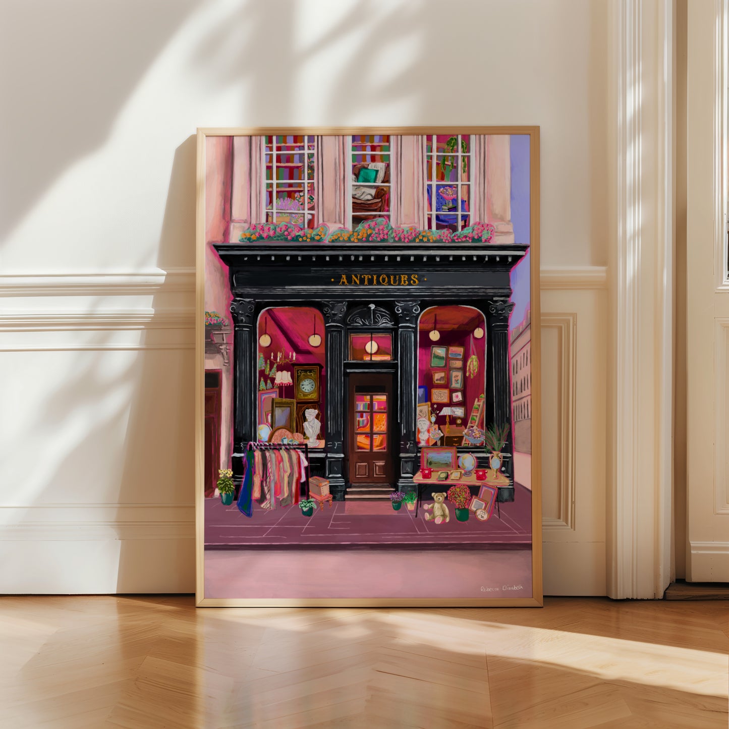 Illustration of a antiques shop front in black with ornate designs, inside is pink and golden with vintage objects such a clocks, statues, picture frames. The illustration gives off dark academia vibes. Designed by Rebecca Elizabeth Draws.
