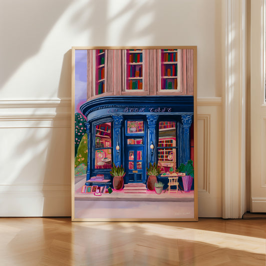 Store front illustration in a deep blue with antique vintage design, inside the book café is a bookcase with jewel tone books, a coffee stand with mugs & cake. The are tables inside and out and upstairs are 3 windows with shelves of books inside. Designed by Rebecca Elizabeth Draws.
