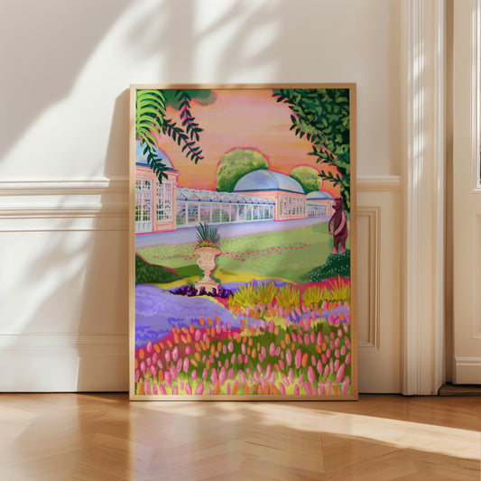 Botanical Gardens in Sheffield Yorkshire. A hand drawn illustration of the glass buildings filled with tropical plants, a field of orange and pink flowers, an orange sky and the bronze bear from the bear pit. Greens, oranges and pink, this illustration is a summery piece that aims to bring joy. A small signature in white the corner. Designed by Rebecca Gibbs at Rebecca Elizabeth Draws.