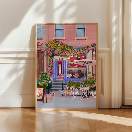 A coffee shop illustration with a blue exterior, an outside table and umbrella and building windows surrounding. This illustration is filled with lots of plants and flowers and features cups of coffee and baked goods. Illustrated by Rebecca Elizabeth Draws.