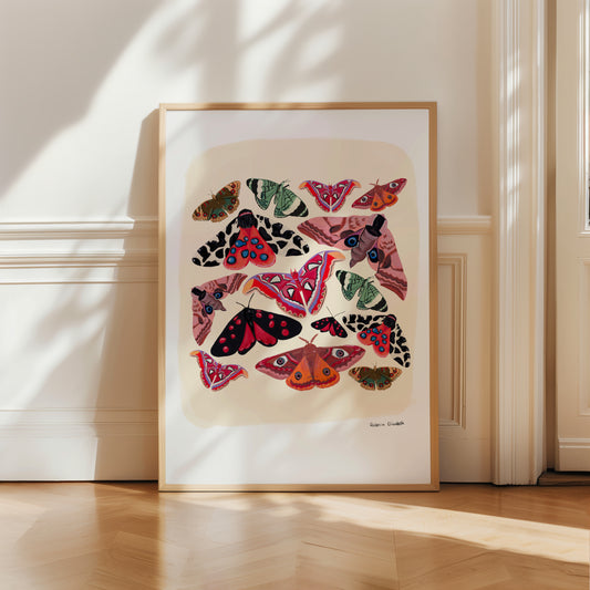 Colourful moths; an atlas moth, garden tiger moth, emperor moth and more. Bright and wonderful butterflies and moths of the world, painted in gouache and edited digitally on procreate into a collaged design on a cream background with a small signature underneath. There is a small signature in black at the right. Designed by Rebecca Gibbs at Rebecca Elizabeth Draws.