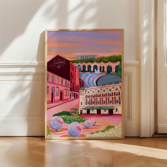 An illustration of Sheffield city, Yorkshire. Featuring The Leadmill, the Lyceum, Sheffield train station, Sheffield Park Hill flats, park hill graffiti and water features. This illustration is very vibrant with bright pinks and oranges, the places featured are collaged together against a purple and orange sky. There is a small signature in white the corner. Designed by Rebecca Gibbs at Rebecca Elizabeth Draws.