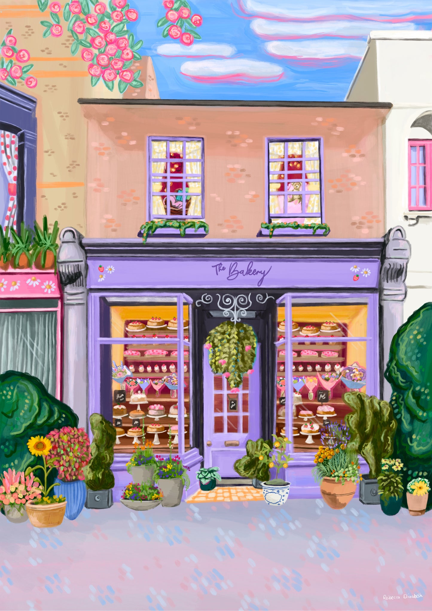 illustration of the bakery, a lilac purple shop front surrounded by older vintage buildings. To the left the window has red polka dot curtains, underneath a pink shop front with daisies on. Above the shop are 2 windows with yellow gingham curtains, a soft brown leather chair & a pink bed with a teddy bear. Inside the bakery the are lots of cakes & cupcakes, bouquets of flowers. Outside the shop there is plant pots full of colourful flowers & sunflowers. The sign has daisies & strawberries on.