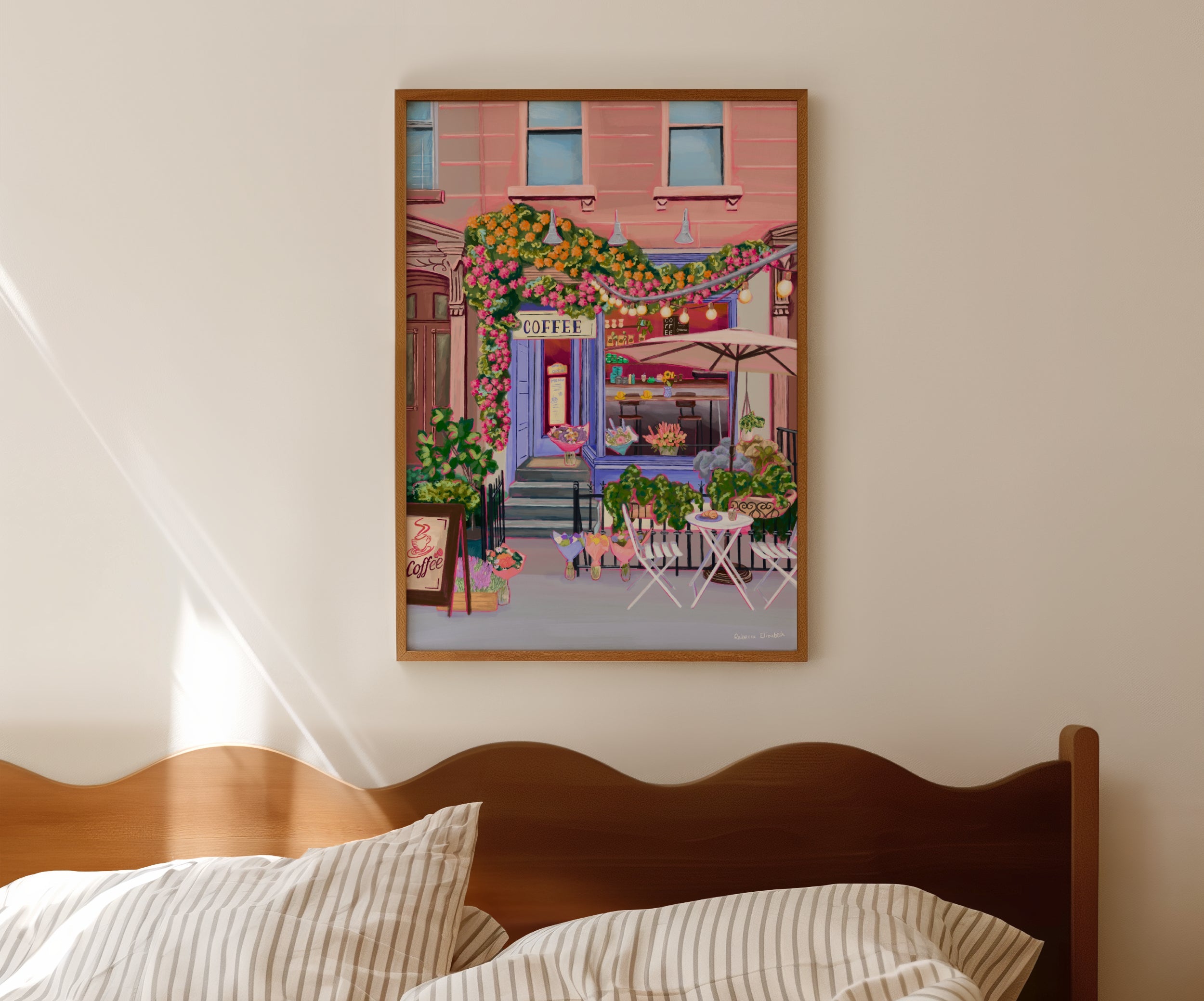 A coffee shop illustration with a blue exterior, an outside table and umbrella and building windows surrounding. This illustration is filled with lots of plants and flowers and features cups of coffee and baked goods. Illustrated by Rebecca Elizabeth Draws.