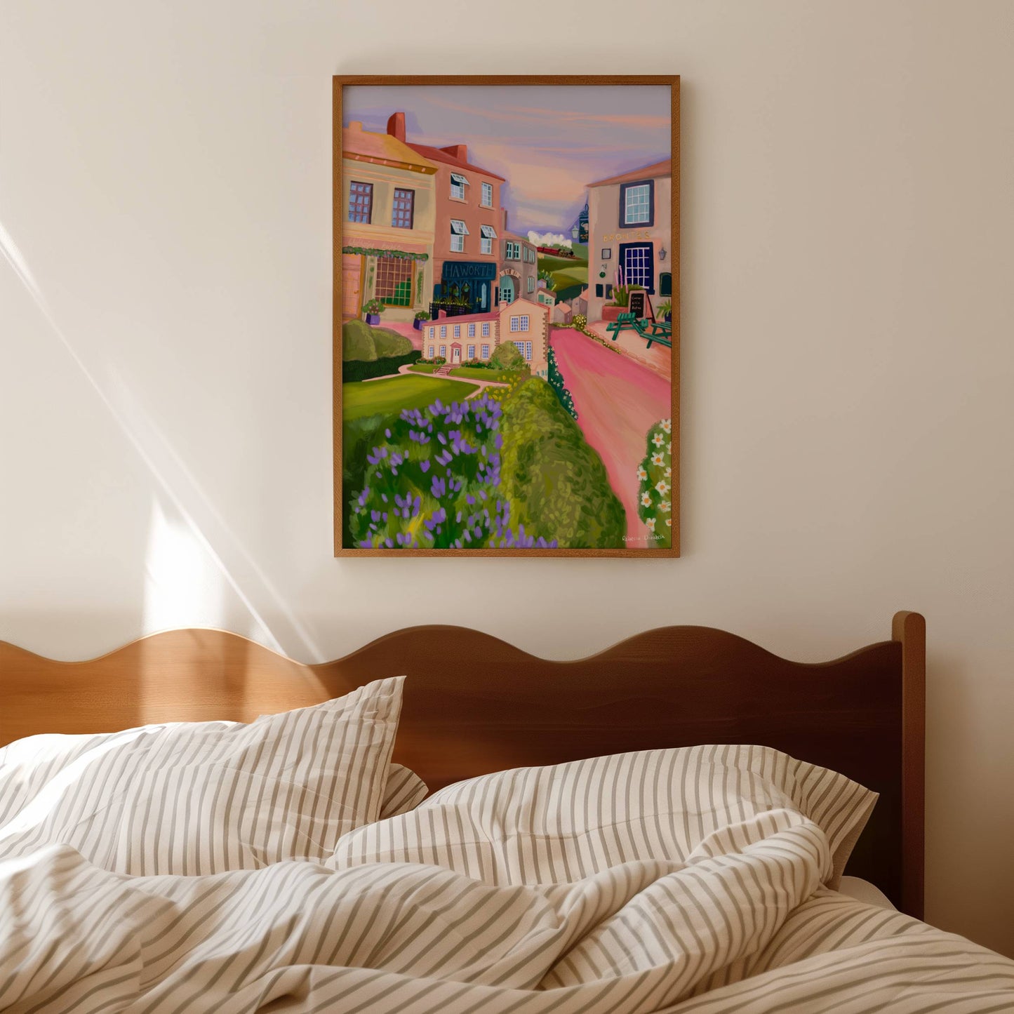 Haworth, the home to the Bronte sisters in Yorkshire. This illustration combines the quaint cobbled streets, the spectacular views across the moors and the Bronte’s family home which is now a museum. In the background there is an illustration of the local steam train that takes you through the Yorkshire countryside. This illustration is designed in soft pink, cream, and lilac colours. A small signature in white the corner. Designed by Rebecca Gibbs at Rebecca Elizabeth Draws.