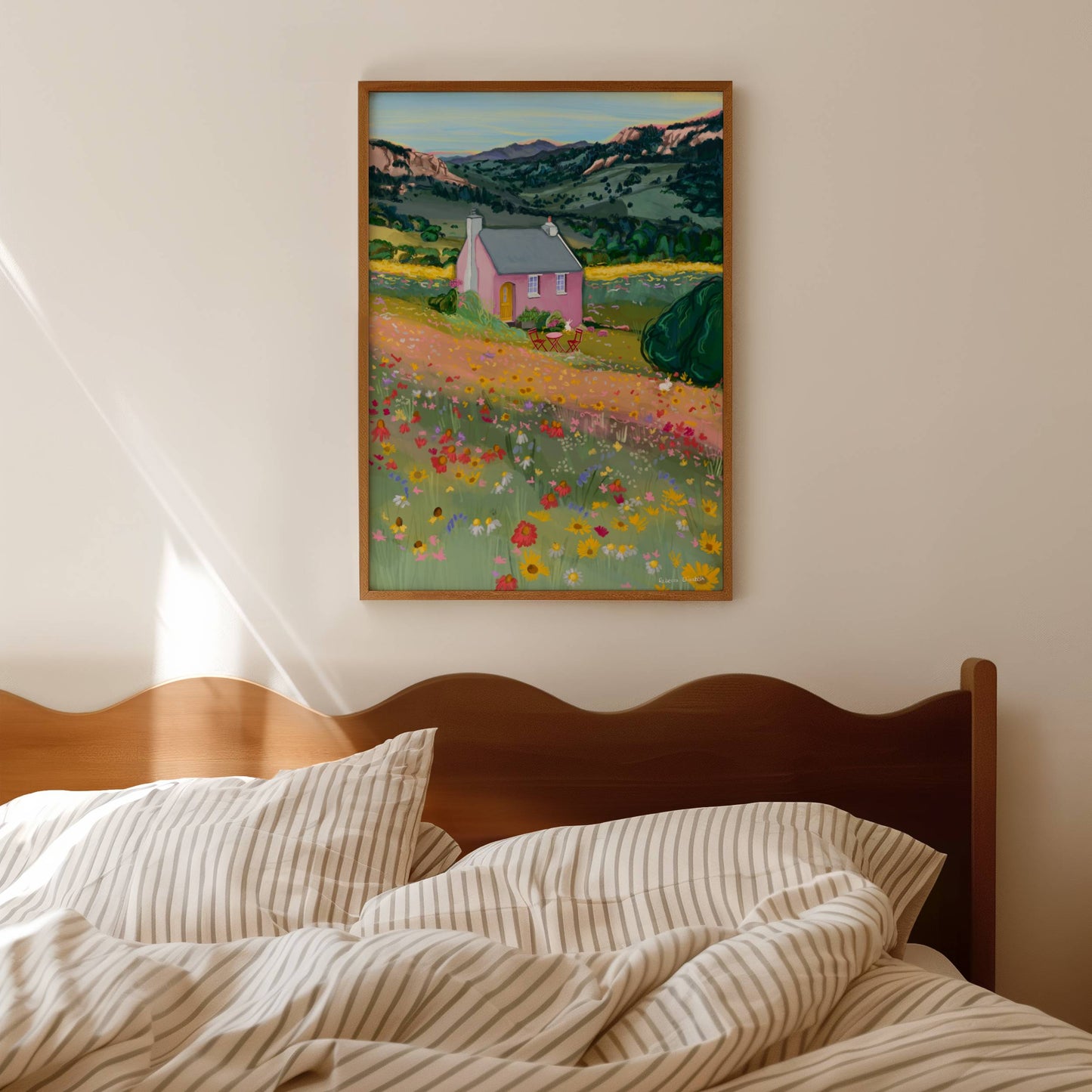 Illustration of a pink house in the mountains in the middle of spring and summer with wildflowers growing all over the surrounding fields in yellow, pink and red.