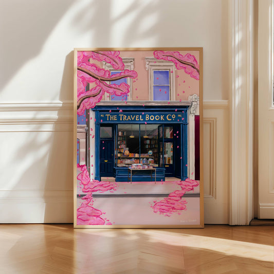 The travel book co from the film Notting hill with a blue bookshop front, old books inside and set in a London building. Outside is a spring blossom tree adding a romantic whimsical aesthetic.