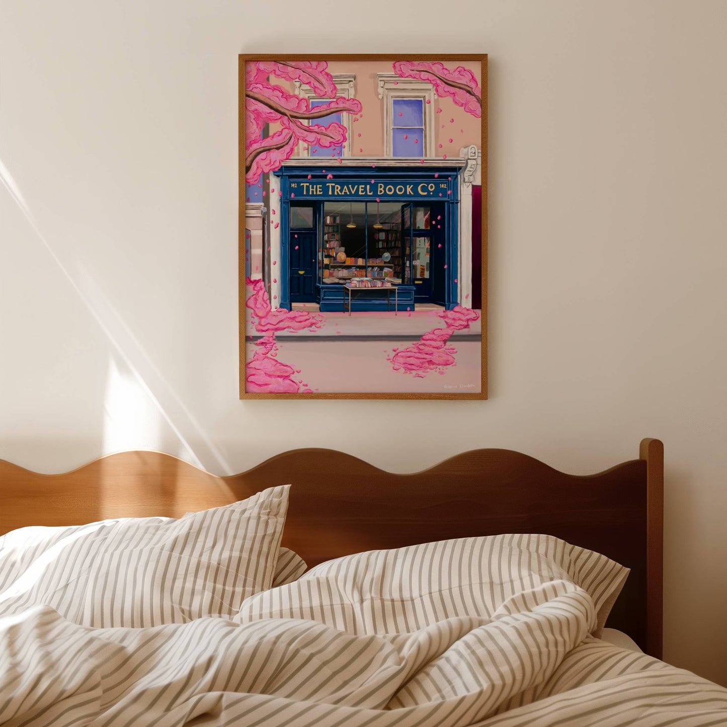 The travel book co from the film Notting hill with a blue bookshop front, old books inside and set in a London building. Outside is a spring blossom tree adding a romantic whimsical aesthetic.