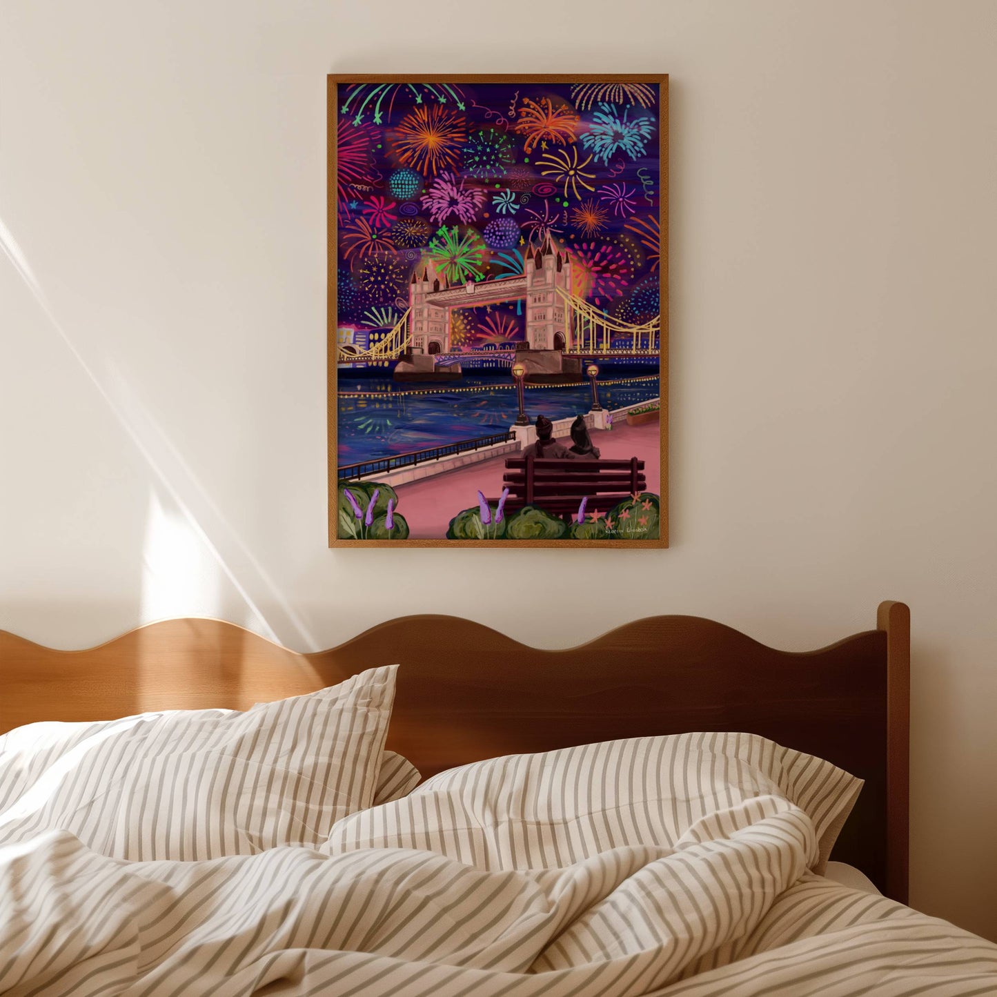 Illustration of bright fireworks in the sky above London city skyline and behind the London tower bridge. The colours are reflected in the river Thames below and in the foreground a couple sit on a bench watching the view.