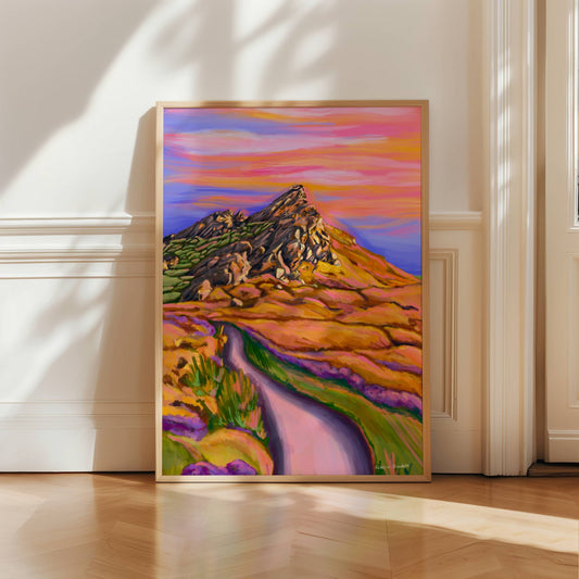 Illustration of Ramshaw rocks leek Staffordshire peak district at sunset. The rocks have orange & pink highlights, surrounded by grass and rocks with a path leading towards it.