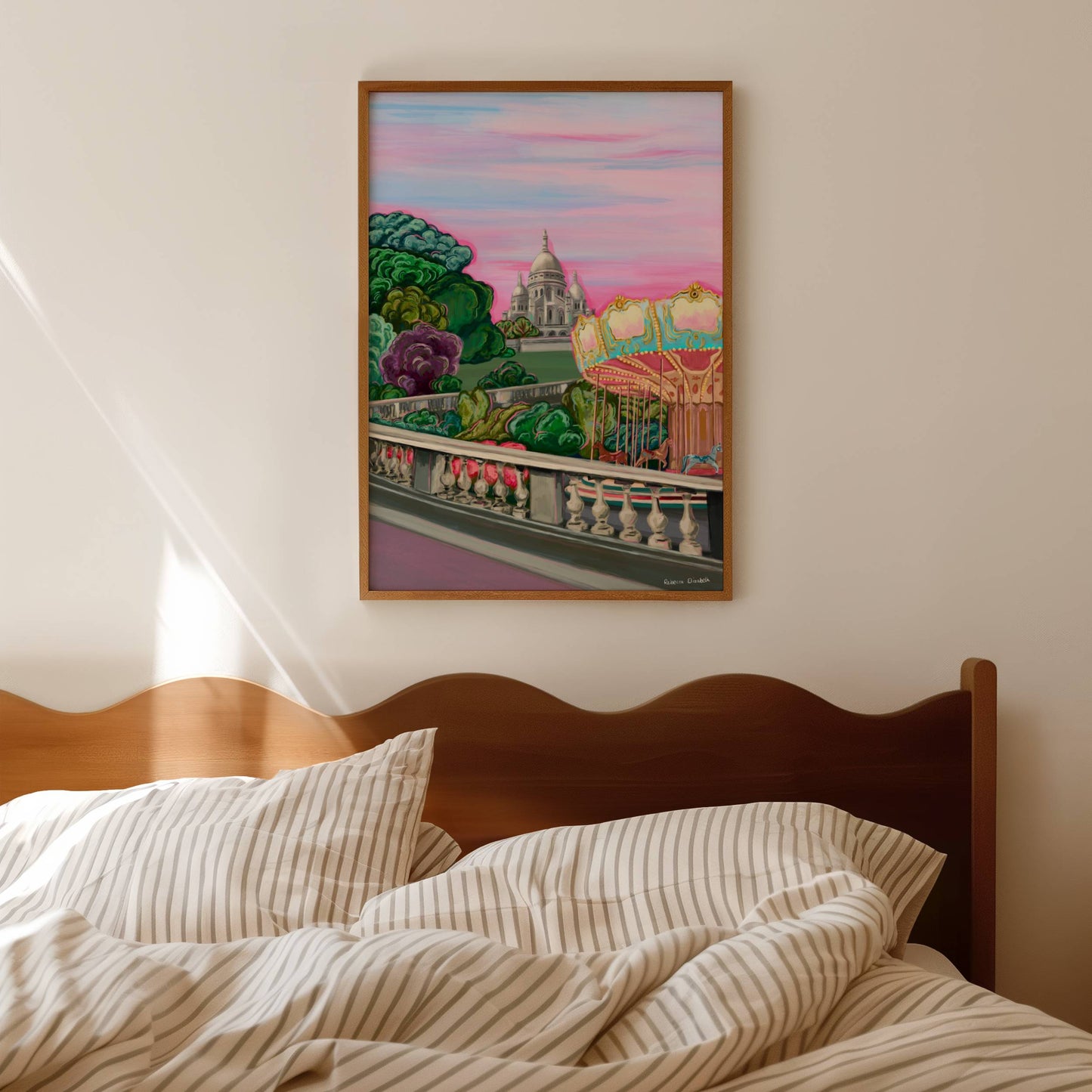 illustration of the Sacre Coeur in Paris France on top of the hill in Montmartre. Set against a pink setting sun sky in Springtime with trees and a merry go round in the foreground.