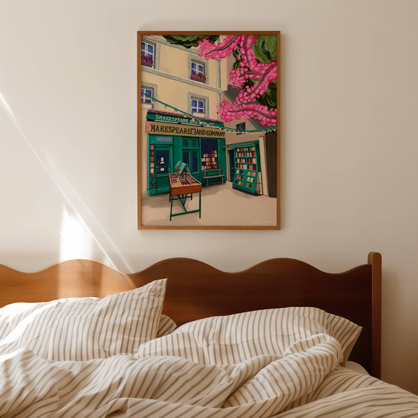 Illustration of Shakespeare and company bookshop in Paris France. with books for sale outside, and a pink cherry blossom tree in the foreground.