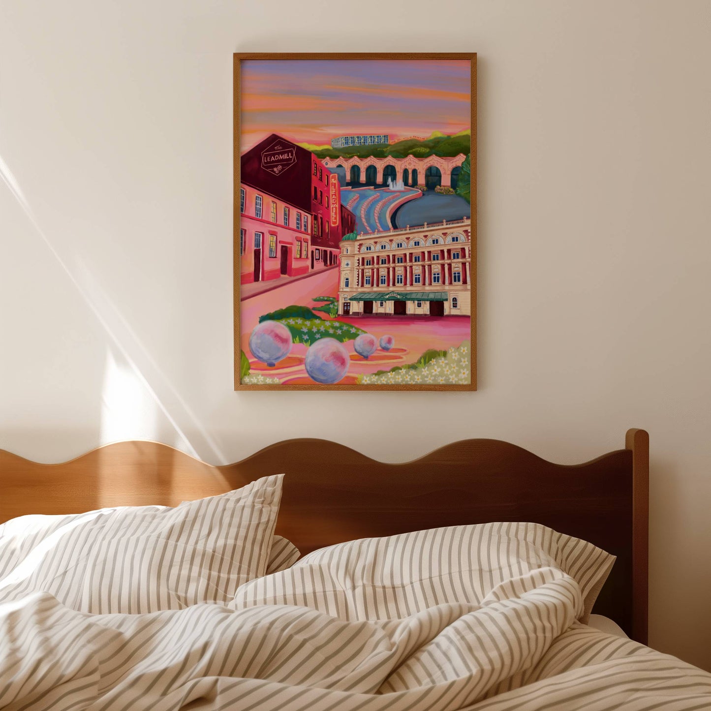 An illustration of Sheffield city, Yorkshire. Featuring The Leadmill, the Lyceum, Sheffield train station, Sheffield Park Hill flats, park hill graffiti and water features. This illustration is very vibrant with bright pinks and oranges, the places featured are collaged together against a purple and orange sky. There is a small signature in white the corner. Designed by Rebecca Gibbs at Rebecca Elizabeth Draws.