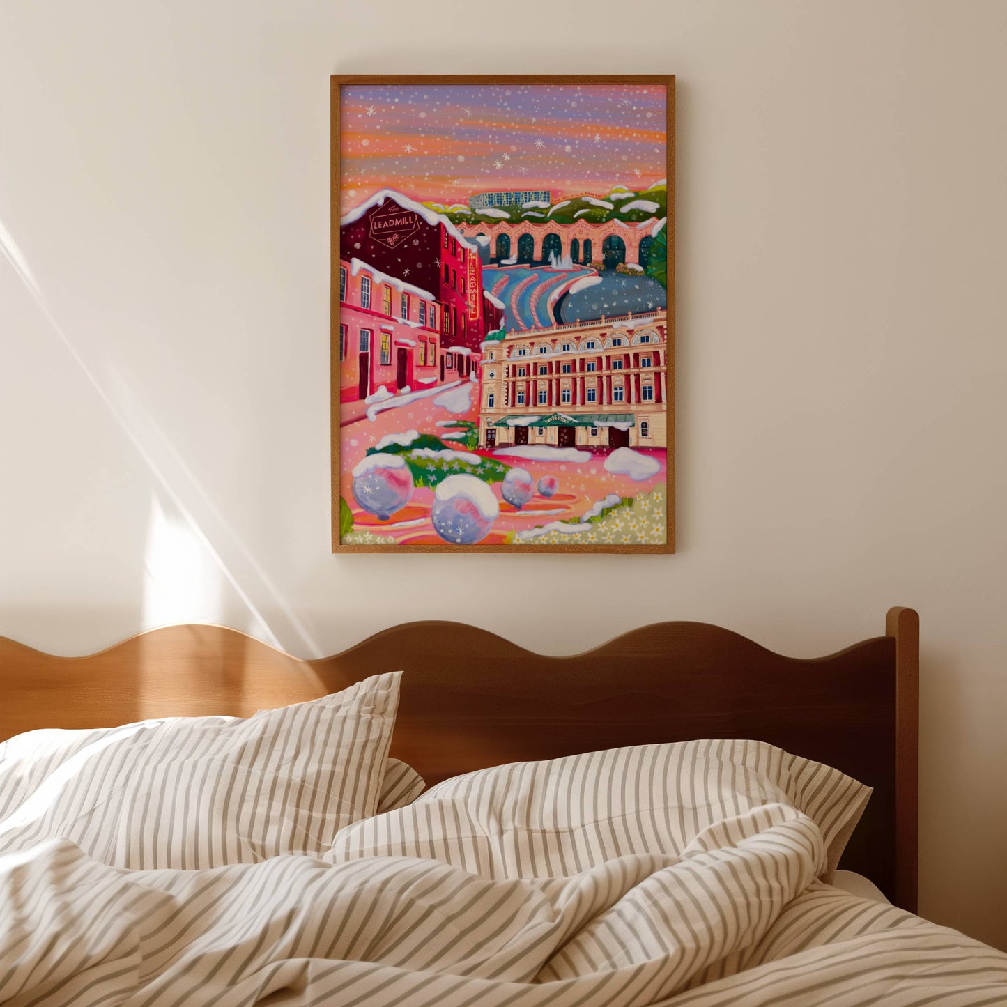 An illustration of Sheffield city in winter with snow. Featuring The Leadmill, the Lyceum, Sheffield train station, Sheffield Park Hill flats, park hill graffiti and water features. This illustration is very vibrant with bright pinks and oranges, the places featured are collaged together against a purple and orange sky. There is a small signature in white the corner. Designed by Rebecca Gibbs at Rebecca Elizabeth Draws.