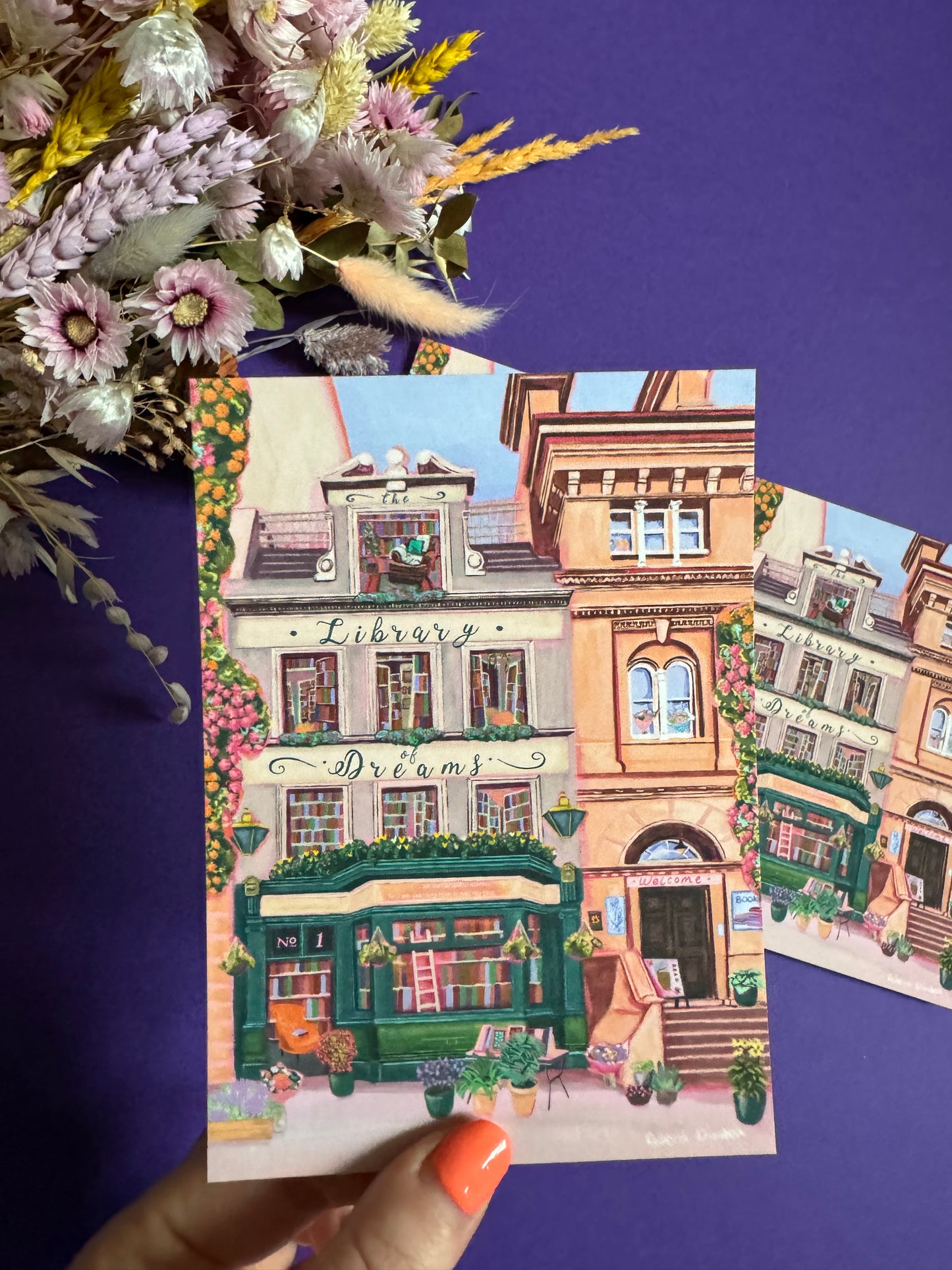 4 storey town house library with windows showing bookcases stacked full of books, covered with flowers & plants. A fantasy library perfect for cosying up with a good book designed by Rebecca Elizabeth Draws