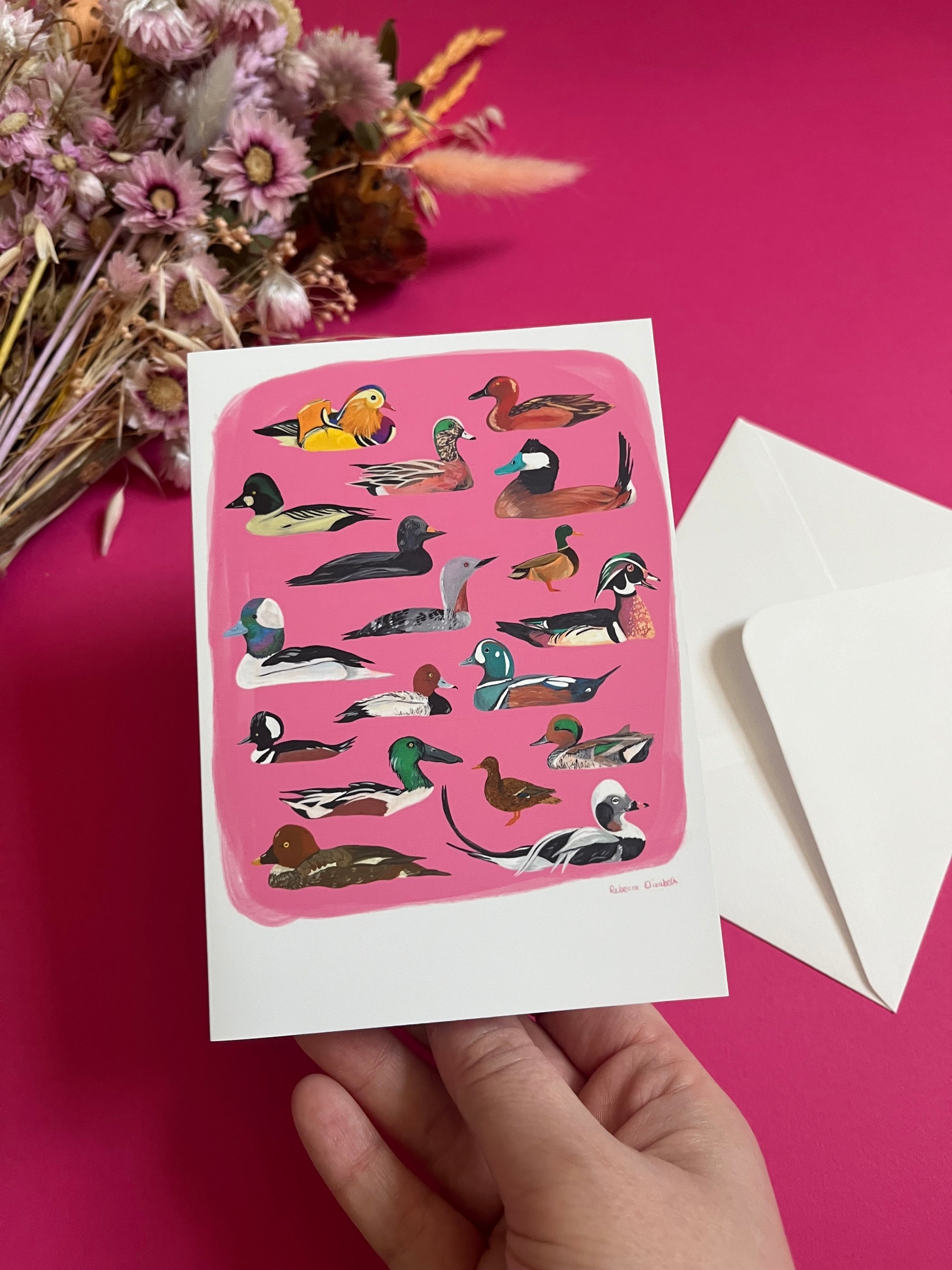 A collection of ducks and birds, hand painted in gouache and then edited digitally into a collaged design on a pink background with the Rebecca Elizabeth Draws logo on the back.