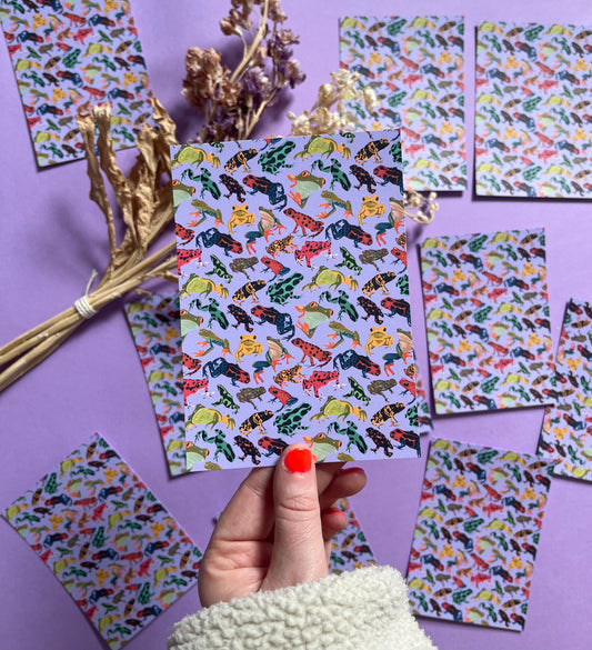 A pattern of vibrant froggies to bring a pop of colour to your life. Hand painted rainforest frogs in gouache and edited digitally into a pattern on a purple background. Now available in a cute postcard.