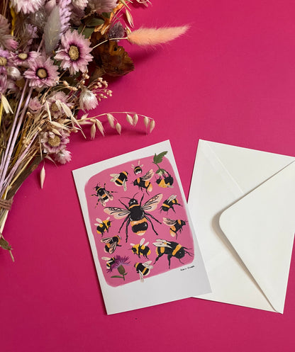 Hand painted bumble bee illustrations compiled together on a pink background, small bees big bees, bees with flowers. The back of the card is green with the Rebecca Elizabeth Draws logo