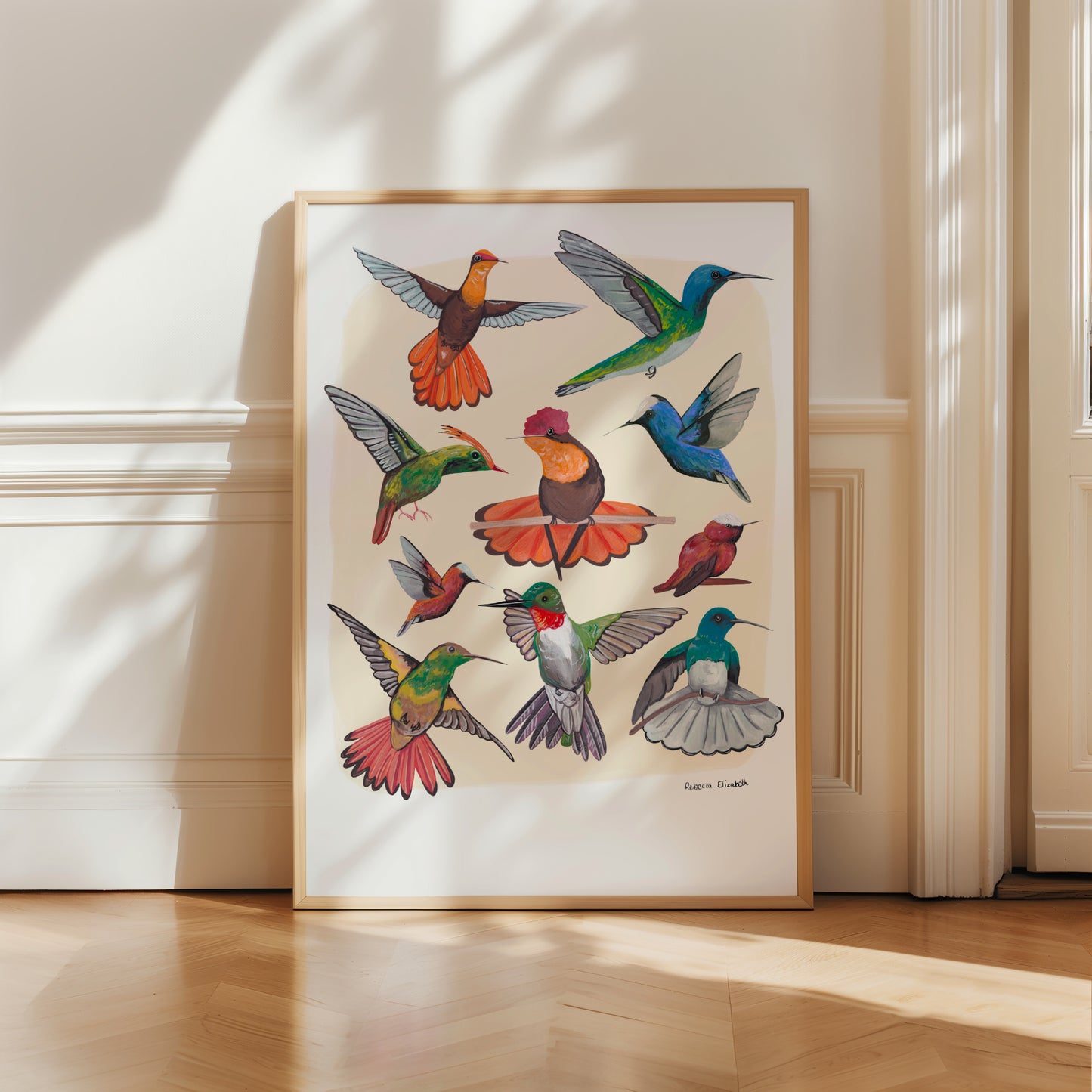 Hummingbirds hand painted in gouache and edited together digitally on a cream background with a small signature featured in the right hand corner. These small birds are green, blue, red, orange and yellow. Designed by Rebecca Gibbs at Rebecca Elizabeth Draws.