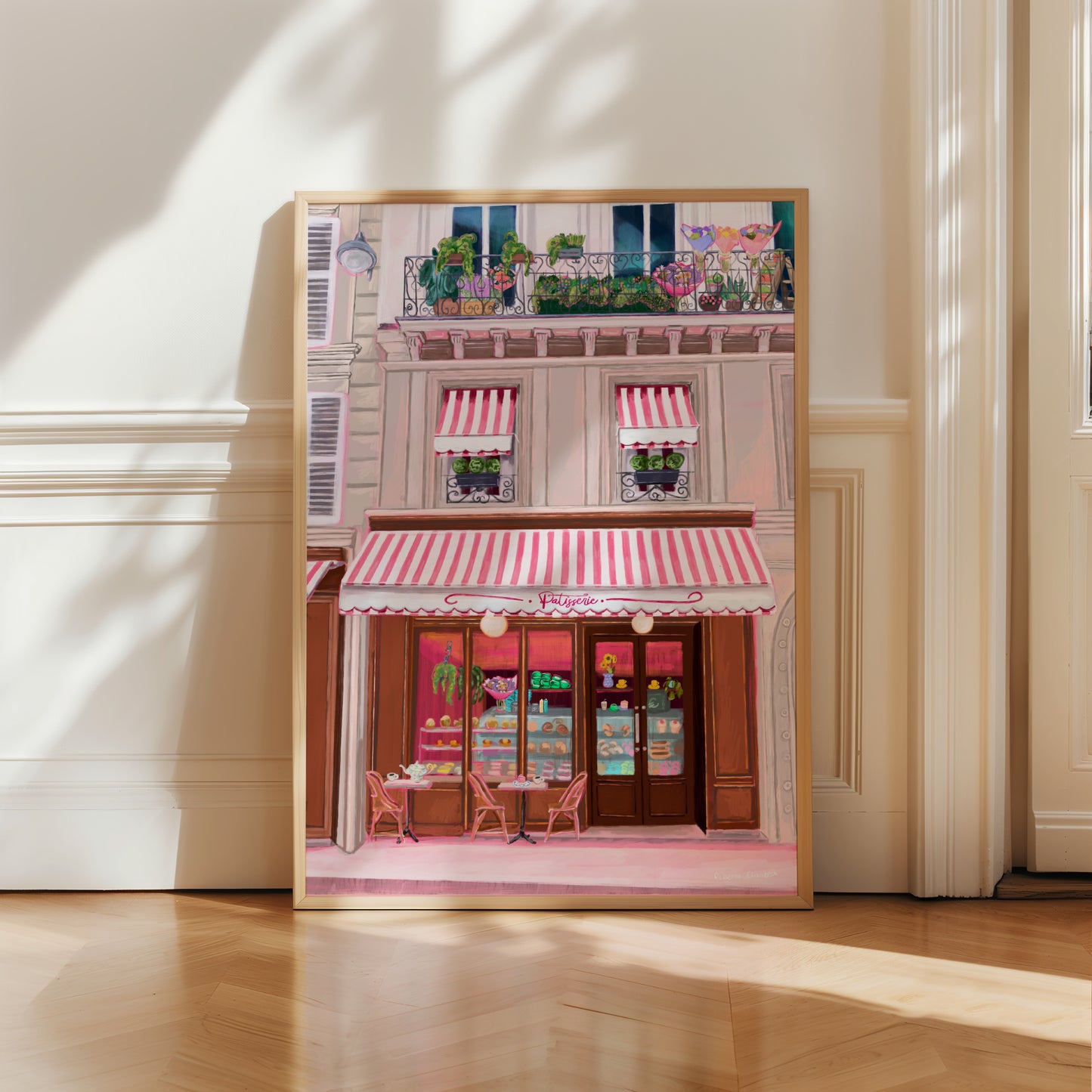 Illustration of a French patisserie , baked goods and pastries in the window with a red and white stripe cloth hanging over the front. Above there are balconies full of flowers and plants. The perfect whimsical art piece designed by Rebecca Elizabeth Draws.