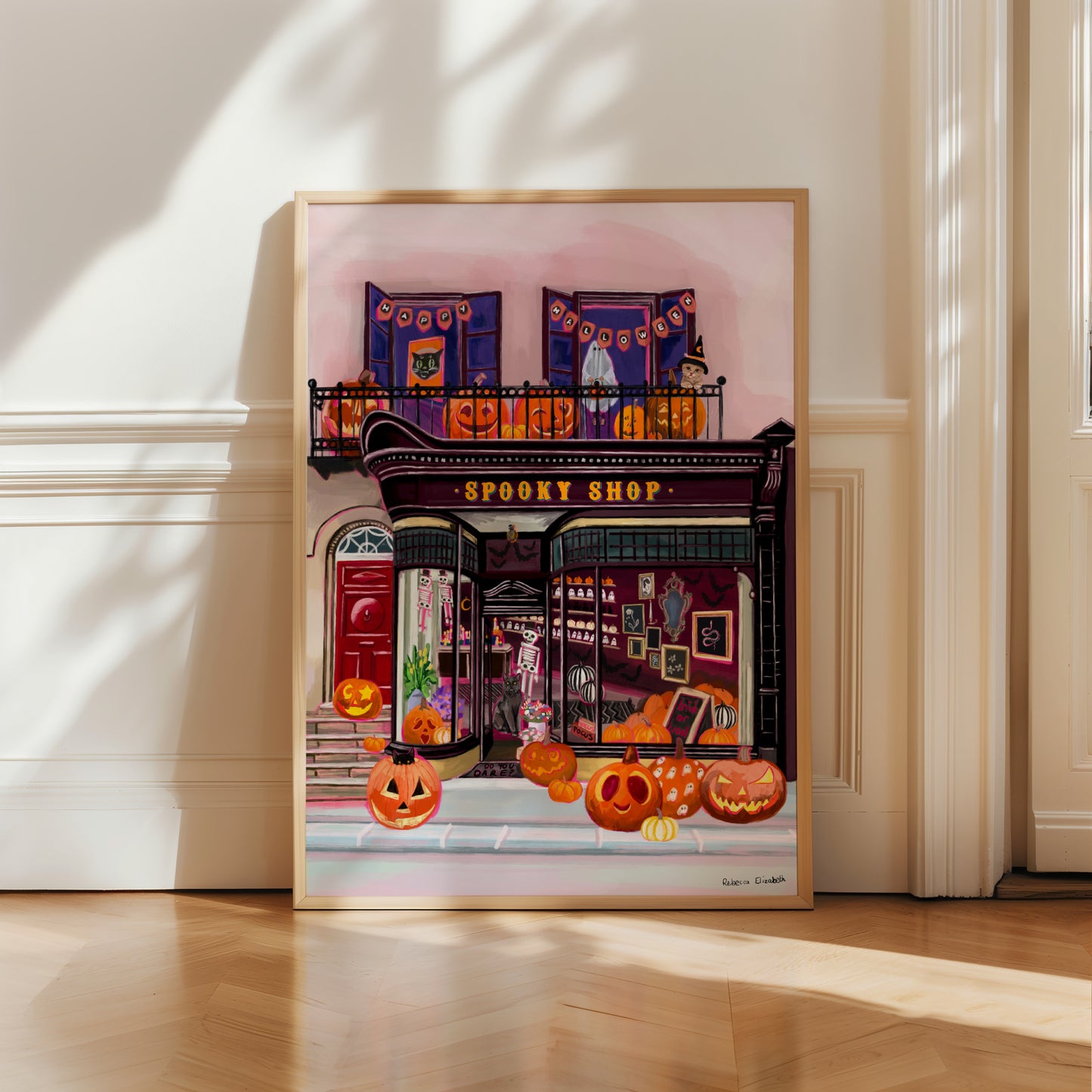 Illustration of a shop front in black with a antique design, inside features lots of spooky toys and pumpkins. On the balcony upstairs are more carved pumpkins, a happy Halloween sign and a kid dressed up as a ghost. A real autumnal spooky art piece.