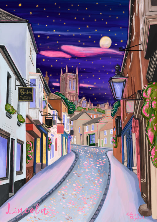 illustration of steep hill in Lincoln, Lincolnshire England UK. IN the background sits Lincoln Cathedral in soft browns & pinks. the sky is a night sky in deep blue with pink cloud tendrils & glittering stars & moon. in the foreground the shops that can be found on steep hill, with a mixture of old fashioned buildings and modern signage. The are pink highlights throughout and little pops of greenery with pink flowers.