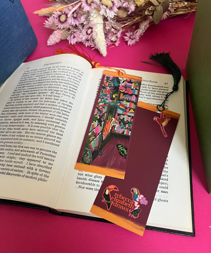 Library illustration taken over by animals. Tiger librarian shelves, toucans & frogs to be found in between the books. Butterflies flutter around. The piece features a bookcases all full of colourful books and tropical birds on the back