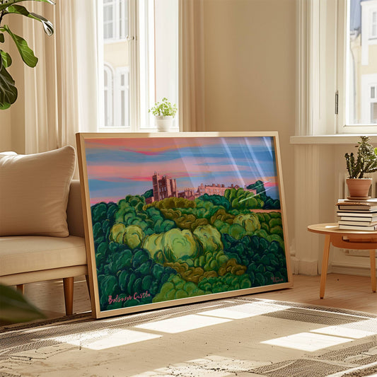 illustration of Bolsover castle, Derbyshire in pinks and purples behind a hill of trees. the sky is pinks and blues with a splash of orange. 