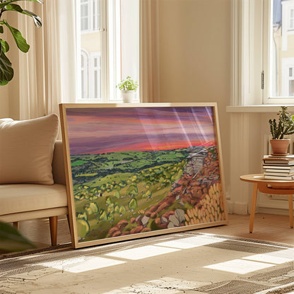 A colourful illustration of Curbar edge, Derbyshire with the rock formation to the right covered in pink and golden flowers, yellow flowers in the foreground and then rolling hills to the left with lots of greenery and trees. A stunning bright pink and purple sunset across the sky.  Designed by  Rebecca Elizabeth draws. 