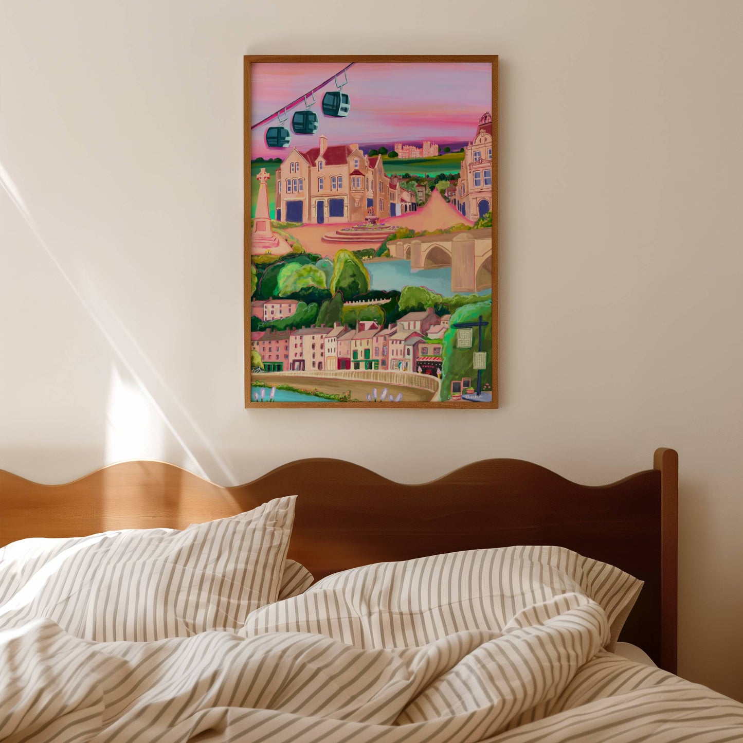 An illustration of Matlock bath and Matlock Derbyshire. Places included are the shops and amusement arcades of Matlock bath, the cable cars and the county offices of Matlock. The war memorial and Riber castle. All set against a pink and purple setting sun sky. 