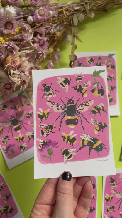 Hand painted bumble bee illustrations compiled together on a pink background, small bees big bees, bees with flowers. A big collection of bees illustrated by Rebecca Elizabeth Draws on a postcard. 