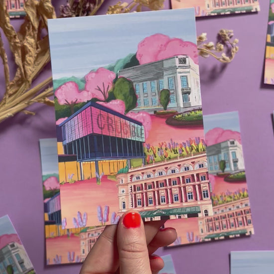 Sheffield theatres illustration, Crucible and Lyceum theatre are illustrated alongside Sheffield library on a background of pink and orange. Trees in both green and pink surround and a baby blue sky. Now available in a cute postcard designed at Rebecca Elizabeth draws. 