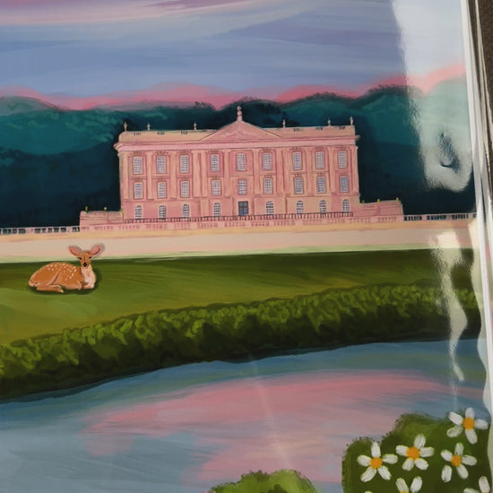 An illustration of Chatsworth house, a stately home found in the Derbyshire Dales. The house is a soft pink surrounded by green trees and fields, a river runs along the front and a deer rests in the foreground. The sky is a soft blue and pink hue, the colours of a beautiful sunset. A small signature in white the corner.  Designed by Rebecca Gibbs at Rebecca Elizabeth Draws.