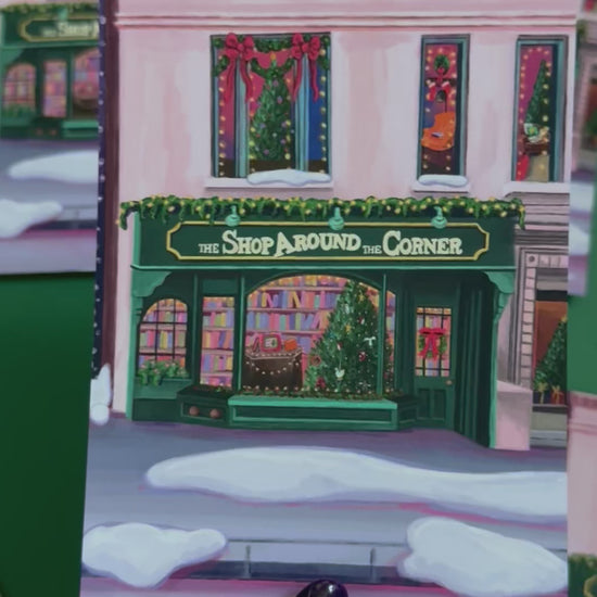 Christmas Illustrated postcard inspired by the film You’ve Got Mail. The Shop Around the Corner is a cosy & whimsical bookshop owned by Kathleen Kelly, inside is lots of fairy lights, Christmas trees, books and baubles. Outside you can see snow and inside the cosy windows with festive decor.  Designed by Rebecca Gibbs at Rebecca Elizabeth Draws.