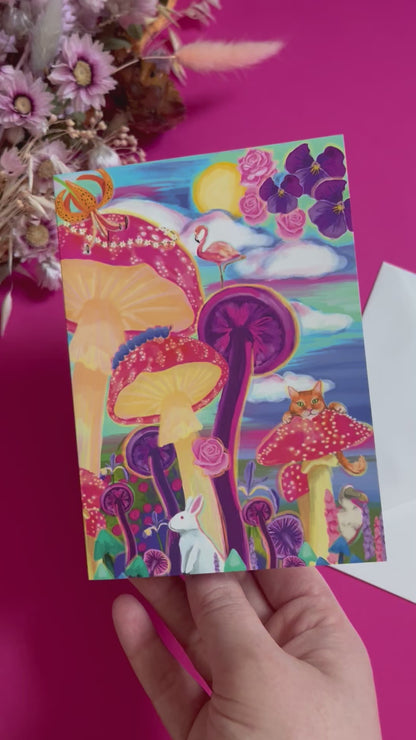 Alice in Wonderland greeting card illustration. A surrealist illustration inspired by alice in wonderland with giant fungi, trippy toadstools, flowers in the sky and much more. Nods to the novel are found throughout from the flamingo to the Cheshire cat and the dodo. Bright pinks, blues and purples, this illustration is very psychedelic. With a blue background and the Rebecca Elizabeth Draws logo.