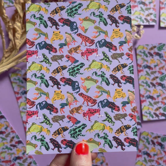 A pattern of vibrant froggies to bring a pop of colour to your life. Hand painted rainforest frogs in gouache and edited digitally into a pattern on a purple background. Now available in a cute postcard.