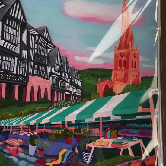 An illustration of the Derbyshire town Chesterfield. A summer illustration featuring the famous crooked spire, market stalls and Tudor buildings. Soft blue sky with fluffy clouds, this art piece is a soft representation of the market town. A small signature in white the corner.  Designed by Rebecca Gibbs at Rebecca Elizabeth Draws.