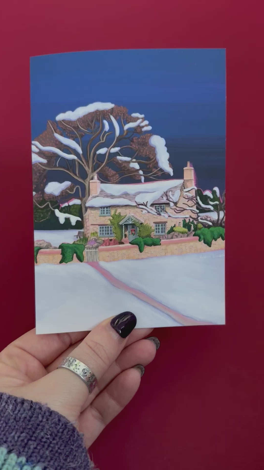 Christmas Illustration of the classic Rosehill cottage from the movie The holiday staring Kate Winslet and Cameron Diaz. Set amongst the English countryside with landscapes of wintery fields, a classic cosy Christmas cottage. Christmas card with pink back designed by Rebecca Gibbs at Rebecca Elizabeth Draws.