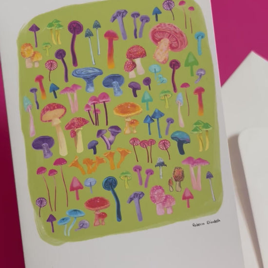 An illustration of all the weird and wonderful mushrooms and fungi you can find. Big ones, small ones, red ones, blue ones and everything inbetween. This illustration is a collaged together piece on a green background on the front of the card. On the back you can find a pink colour and the Rebecca Elizabeth draws logo along with the information the card is blank inside. Designed by Rebecca Gibbs on a postcard at Rebecca Elizabeth Draws.