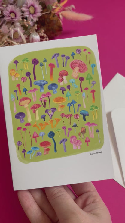 An illustration of all the weird and wonderful mushrooms and fungi you can find. Big ones, small ones, red ones, blue ones and everything inbetween. This illustration is a collaged together piece on a green background on the front of the card. On the back you can find a pink colour and the Rebecca Elizabeth draws logo along with the information the card is blank inside. Designed by Rebecca Gibbs on a postcard at Rebecca Elizabeth Draws.