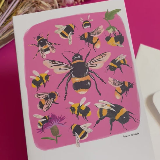 Hand painted bumble bee illustrations compiled together on a pink background, small bees big bees, bees with flowers. The back of the card is green with the Rebecca Elizabeth Draws logo