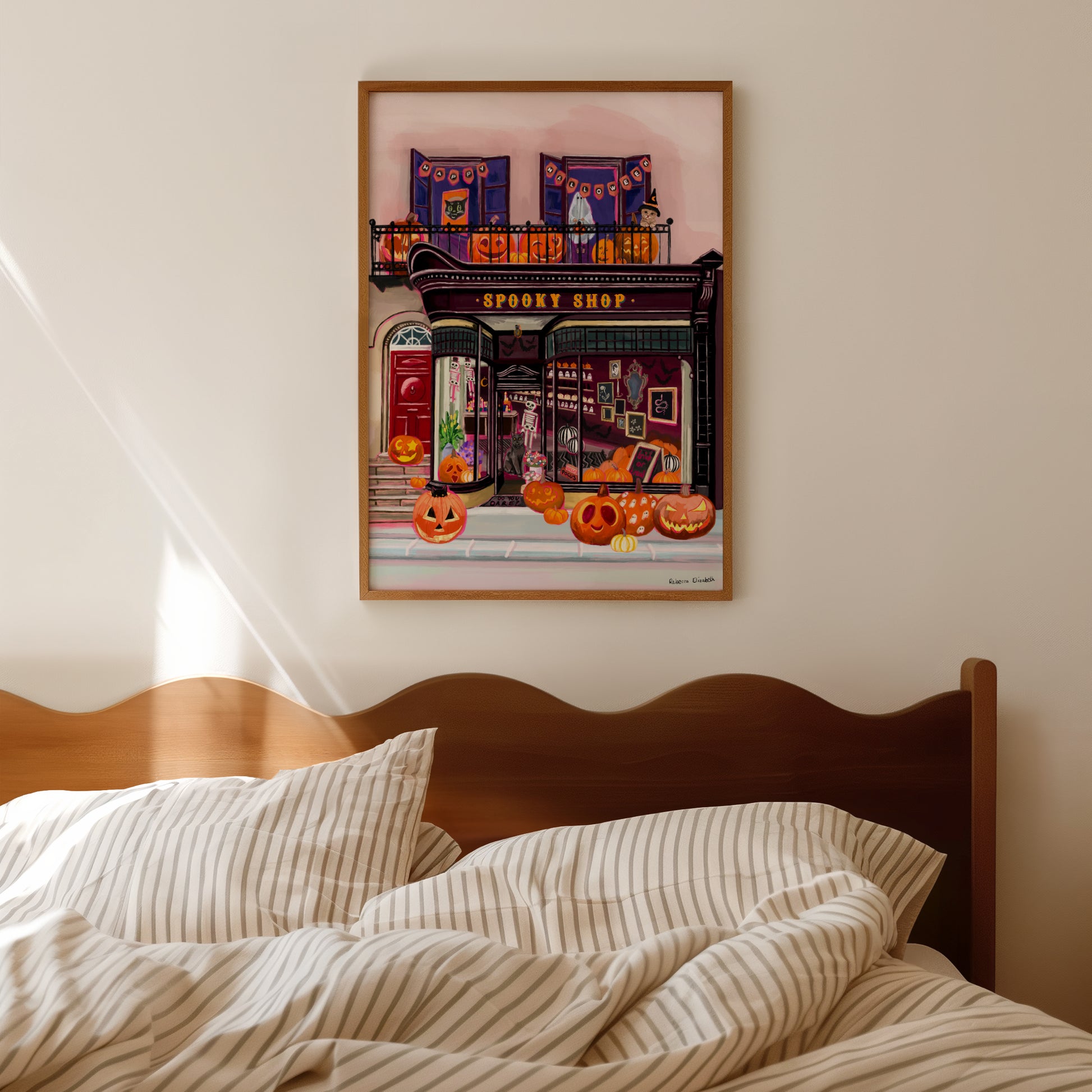 Illustration of a shop front in black with a antique design, inside features lots of spooky toys and pumpkins. On the balcony upstairs are more carved pumpkins, a happy Halloween sign and a kid dressed up as a ghost. A real autumnal spooky art piece.