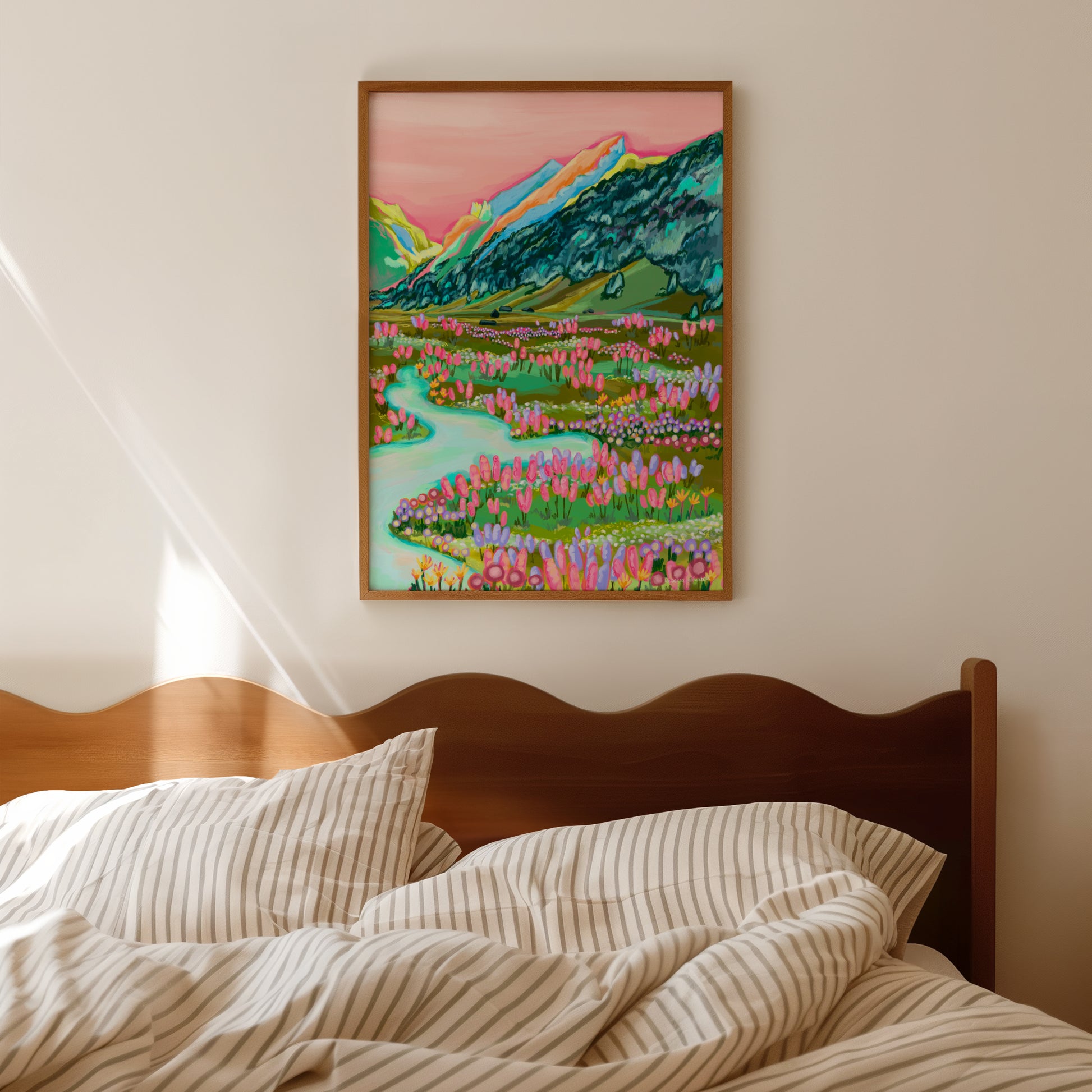 An illustration inspired by the swiss alps of mountains in green, yellow, orange and pink with a coral sky and lots of trees climbing the sides in dark teal. At the base of the hill are cabins, a river and lots of wild flowers growing. Designed by Rebecca Elizabeth Draws